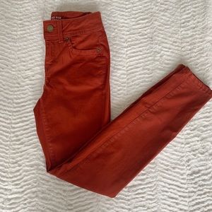 Mid-rise rust colored skinny jeans
